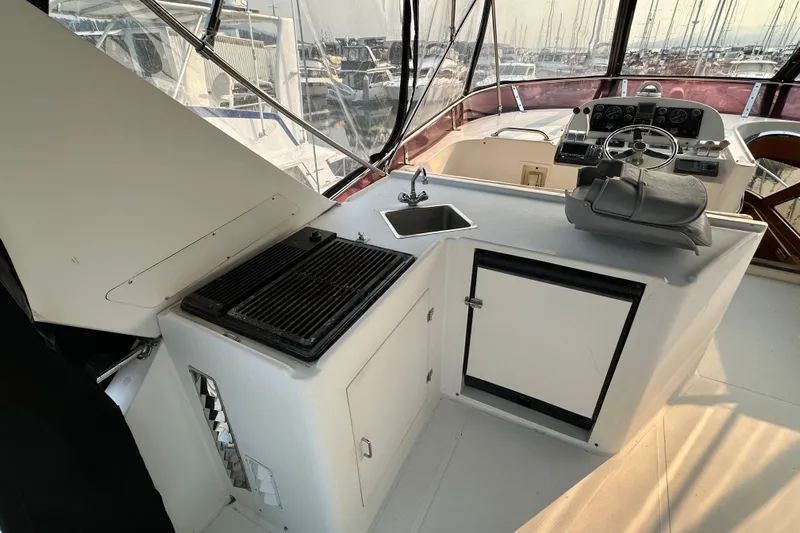 Sunchaser Yacht Photos Pics Interior of 1999 Hampton 490 yacht with helm, grill, and sink.