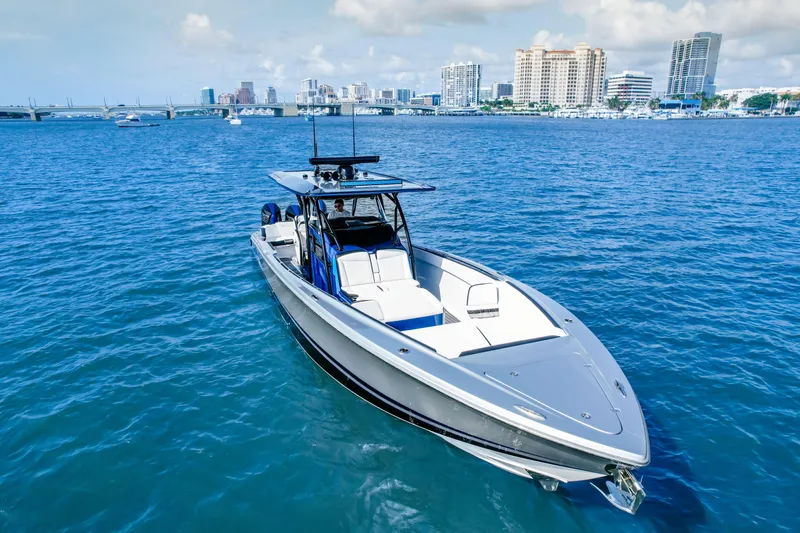  Yacht Photos Pics 2022 Nor-Tech 390 Center Console boat on blue water with city skyline background.