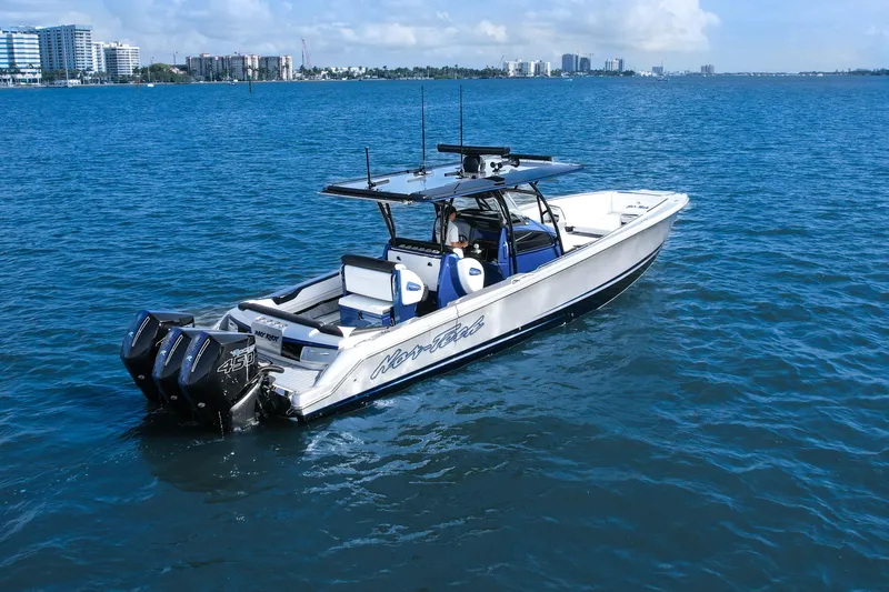  Yacht Photos Pics 2022 Nor-Tech 390 Center Console boat cruising on blue water near city skyline.