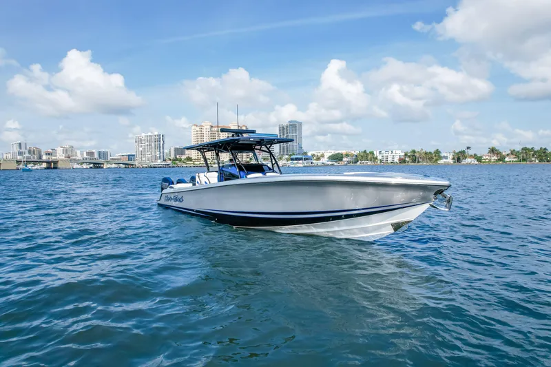  Yacht Photos Pics 2022 Nor-Tech 390 Center Console boat on water with city skyline background.