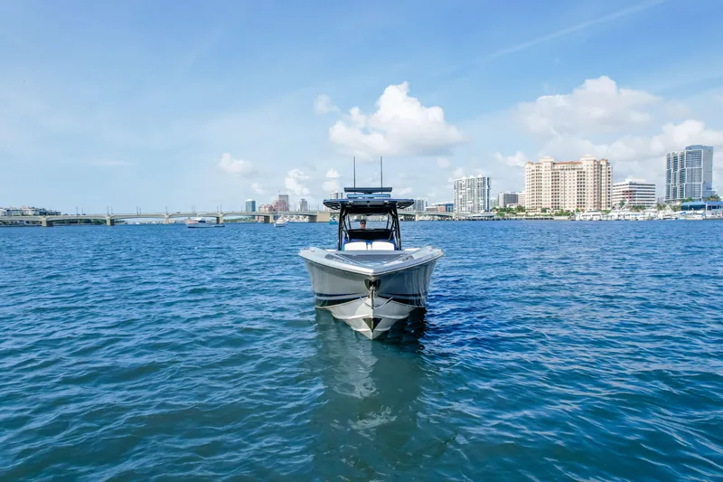 Yacht Photos Pics 2022 Nor-Tech 390 Center Console boat on water with city skyline background.