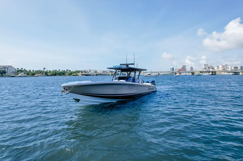  Yacht Photos Pics 2022 Nor-Tech 390 Center Console boat on calm water with cityscape background.