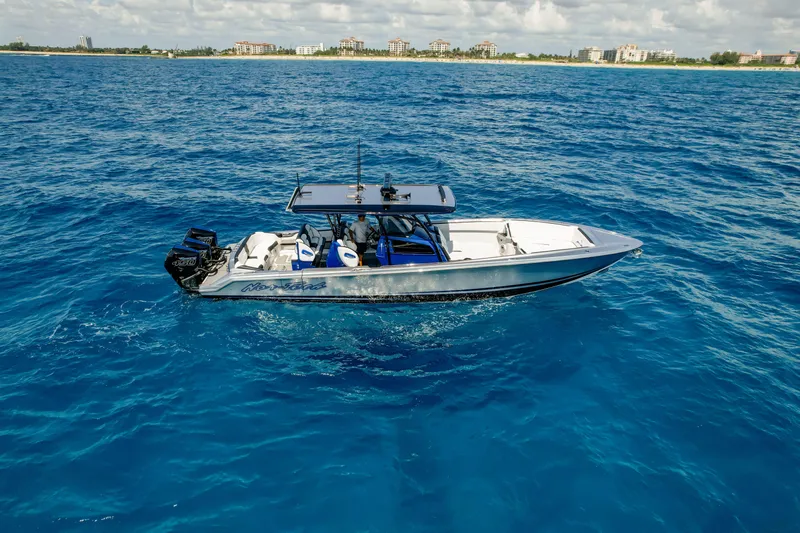  Yacht Photos Pics 2022 Nor-Tech 390 Center Console boat cruising on clear blue ocean waters.