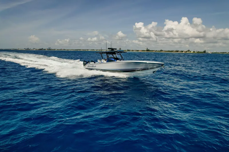 Yacht Photos Pics 2022 Nor-Tech 390 Center Console boat cruising on open blue ocean under clear sky.