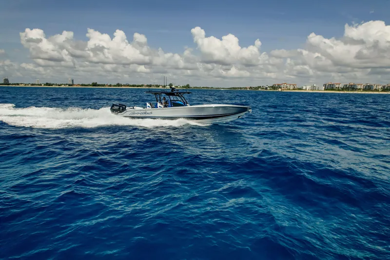  Yacht Photos Pics 2022 Nor-Tech 390 Center Console cruising on open blue ocean under cloudy sky.