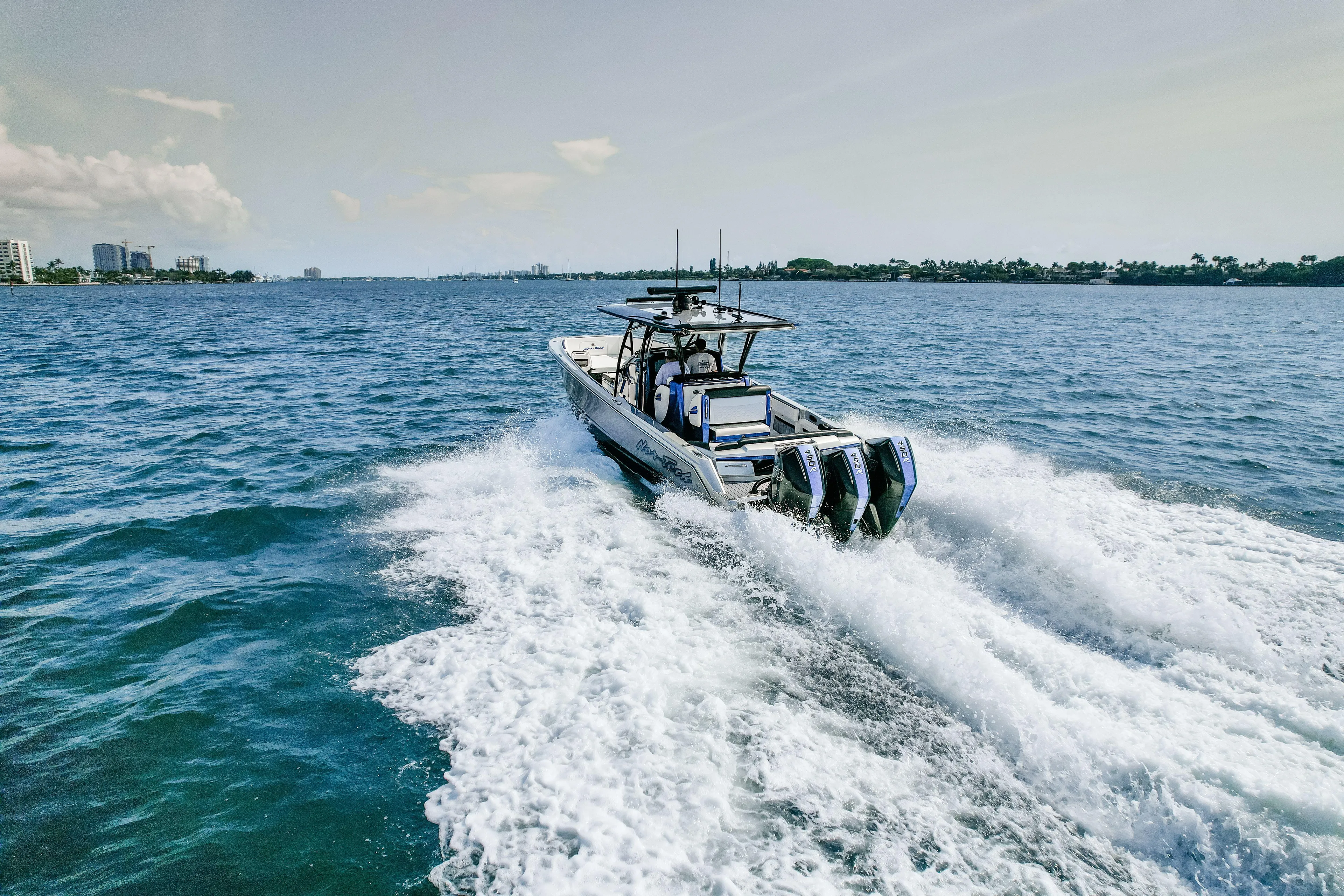  Yacht Photos Pics 2022 Nor-Tech 390 Center Console boat cruising on open water, creating a wake.