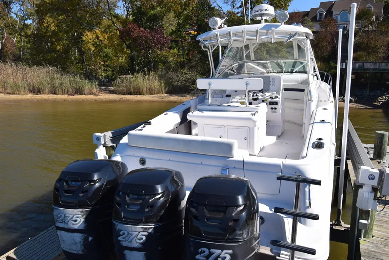 Tie Me Up Yacht Photos Pics 2005 Donzi 38 ZSF boat with triple 275 engines docked by a scenic shoreline.