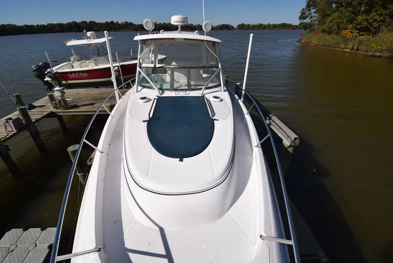 Tie Me Up Yacht Photos Pics 2005 Donzi 38 ZSF boat docked on a calm lake with clear skies.