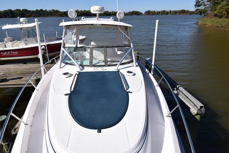 Tie Me Up Yacht Photos Pics 2005 Donzi 38 ZSF boat docked on a calm lake with clear skies.