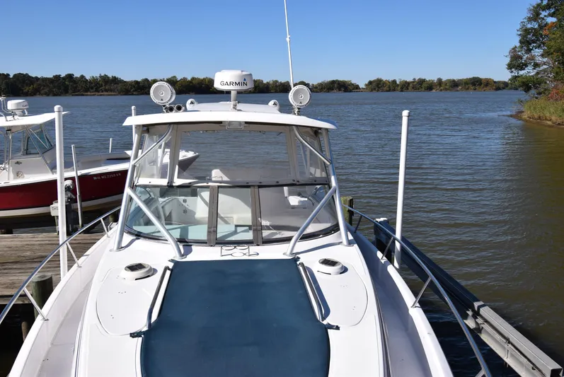 Tie Me Up Yacht Photos Pics 2005 Donzi 38 ZSF boat docked on a calm lake with clear blue skies.