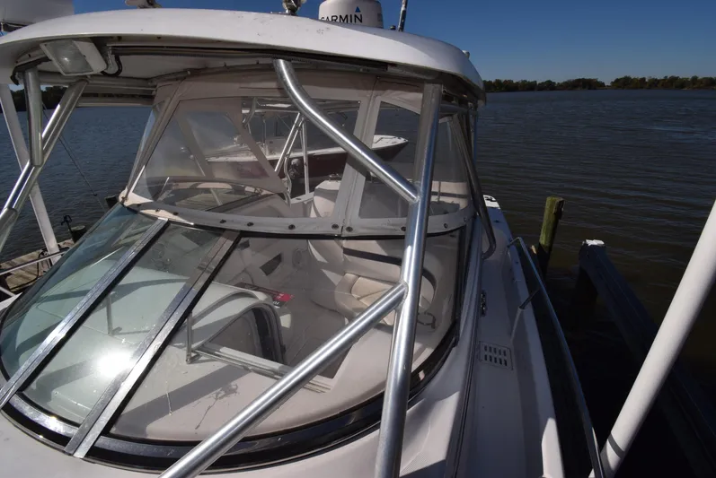 Tie Me Up Yacht Photos Pics 2005 Donzi 38 ZSF boat docked by the water on a sunny day.