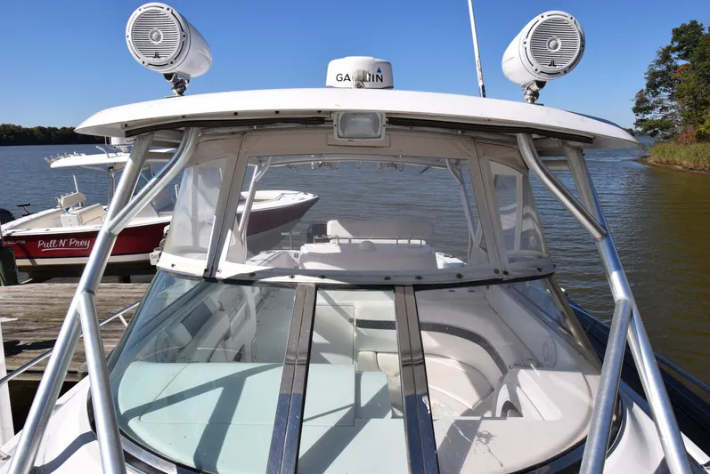 Tie Me Up Yacht Photos Pics 2005 Donzi 38 ZSF boat docked on a sunny day, featuring a sleek design and modern equipment.