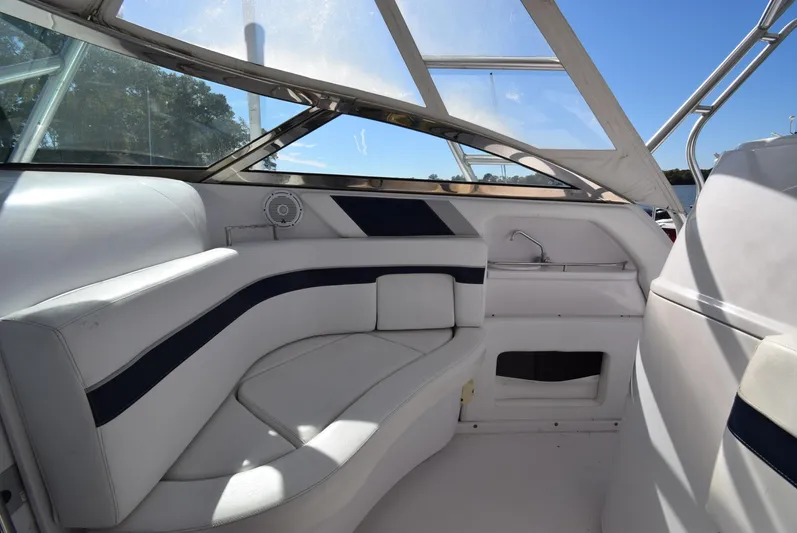 Tie Me Up Yacht Photos Pics Interior of a 2005 Donzi 38 ZSF boat with white seating and blue accents.