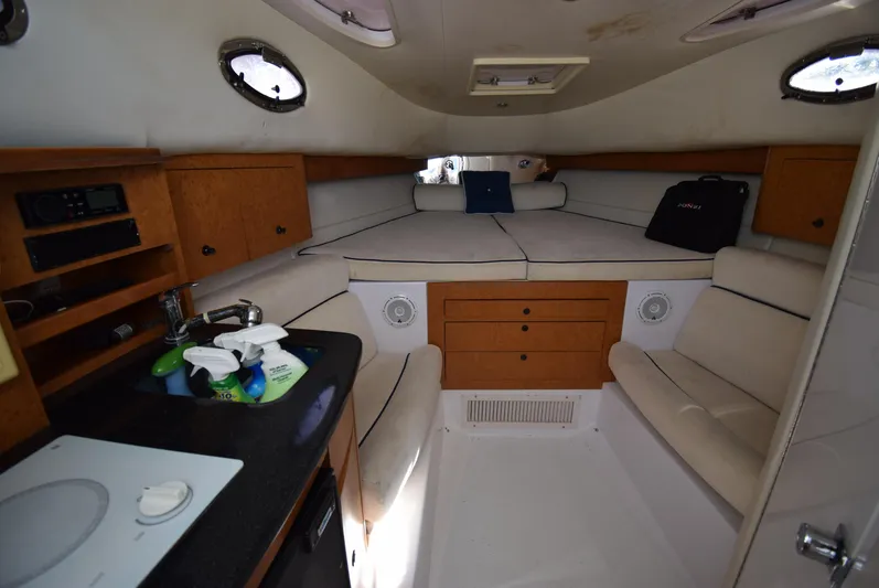 Tie Me Up Yacht Photos Pics Interior of 2005 Donzi 38 ZSF boat with cozy seating and compact kitchenette.