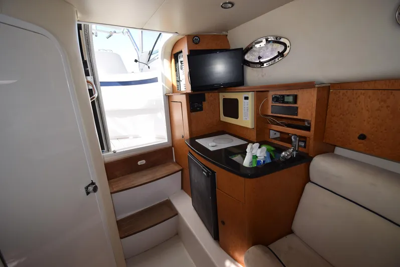 Tie Me Up Yacht Photos Pics Interior of 2005 Donzi 38 ZSF boat with kitchenette, TV, and seating area.