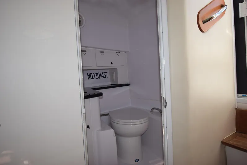 Tie Me Up Yacht Photos Pics 2005 Donzi 38 ZSF boat bathroom interior with toilet and storage cabinets.