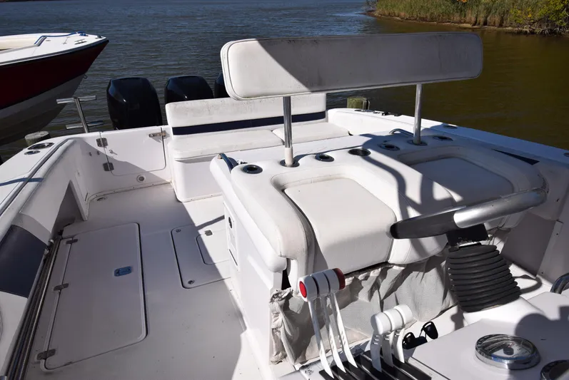 Tie Me Up Yacht Photos Pics 2005 Donzi 38 ZSF boat interior with helm and seating, docked on calm water.