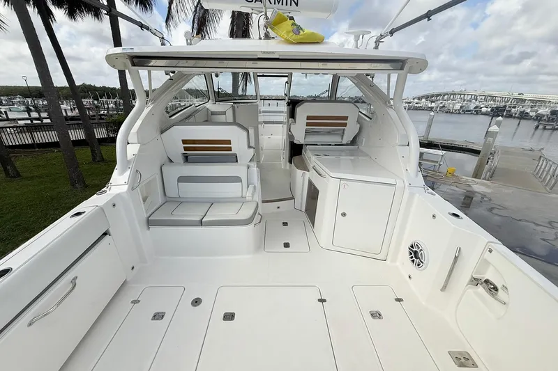 Salty Girl Yacht Photos Pics 2022 Pursuit DC 365 Dual Console boat interior at marina, showcasing seating and storage.