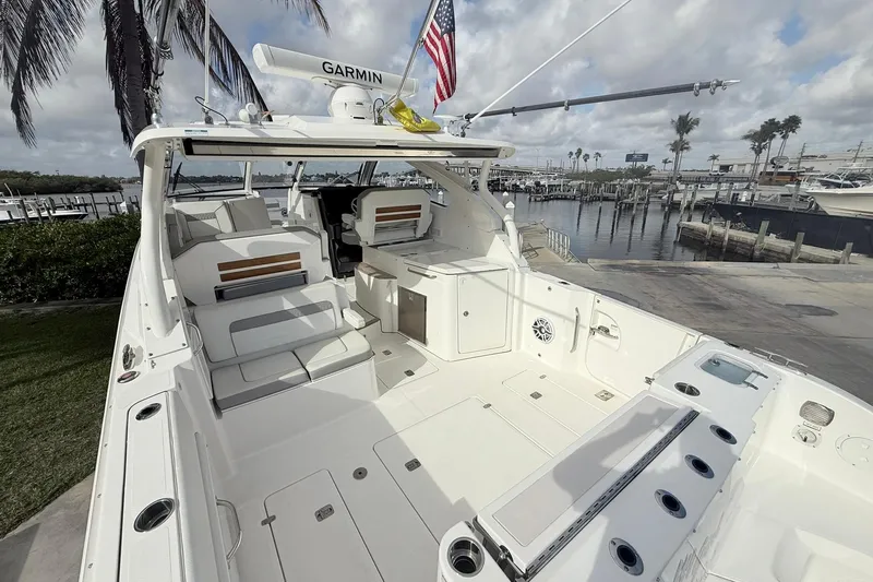 Salty Girl Yacht Photos Pics 2022 Pursuit DC 365 Dual Console boat docked, featuring spacious seating and modern amenities.