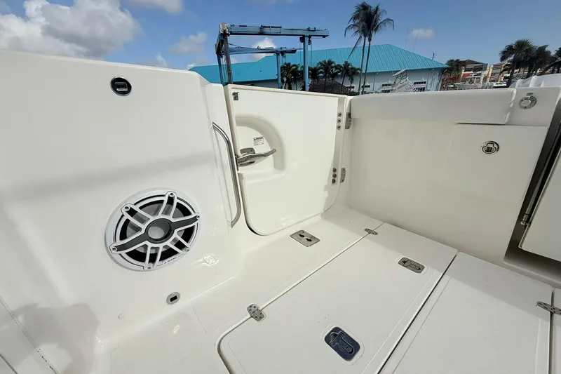 Salty Girl Yacht Photos Pics 2022 Pursuit DC 365 Dual Console boat interior with speaker and storage compartments.
