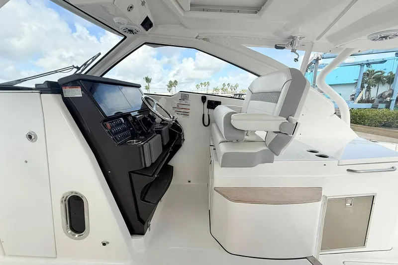 Salty Girl Yacht Photos Pics 2022 Pursuit DC 365 Dual Console interior with helm and seating, showcasing modern design.