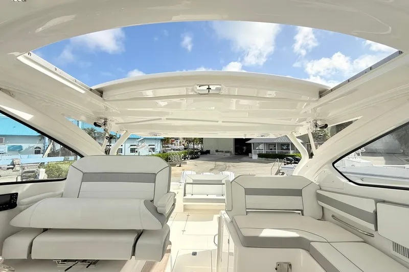 Salty Girl Yacht Photos Pics 2022 Pursuit DC 365 Dual Console boat interior with spacious seating and open roof.