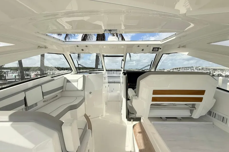 Salty Girl Yacht Photos Pics 2022 Pursuit DC 365 Dual Console interior with sleek seating and panoramic windows.