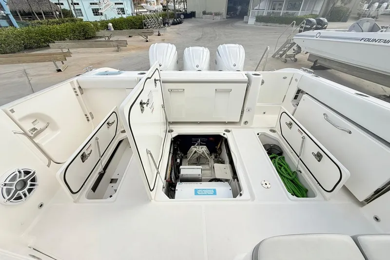 Salty Girl Yacht Photos Pics 2022 Pursuit DC 365 Dual Console boat with open storage compartments and visible engine.