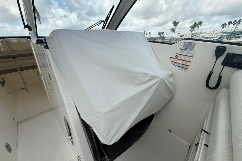 Salty Girl Yacht Photos Pics 2022 Pursuit DC 365 Dual Console boat interior with covered console and marine equipment.