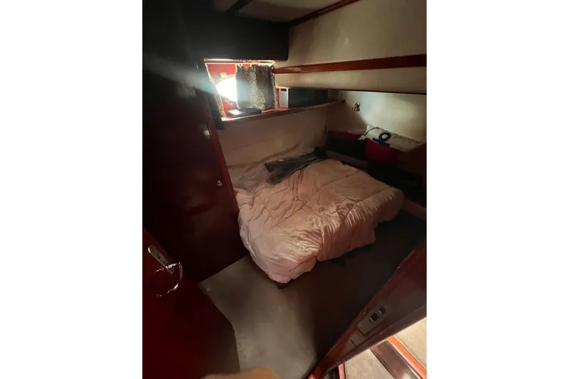 Nickys Yacht Photos Pics Cozy cabin interior of 2003 Uniesse 48 Fly yacht with bed and window.