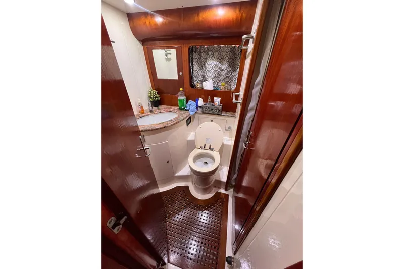 Nickys Yacht Photos Pics Luxurious bathroom in 2003 Uniesse 48 Fly yacht with wooden accents and modern amenities.