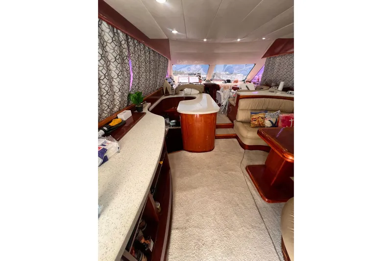 Nickys Yacht Photos Pics Luxurious interior of 2003 Uniesse 48 Fly yacht with elegant seating and modern amenities.