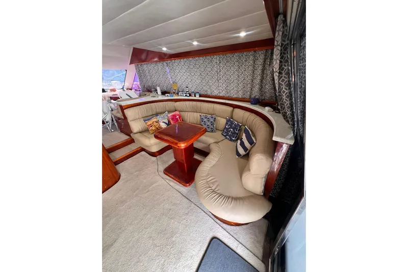 Nickys Yacht Photos Pics Luxurious interior of 2003 Uniesse 48 Fly yacht with plush seating and decorative pillows.