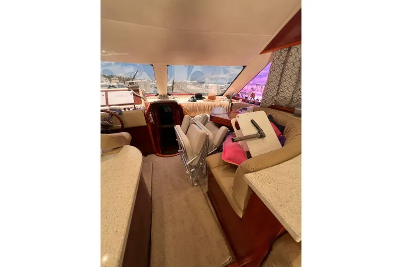 Nickys Yacht Photos Pics Interior of 2003 Uniesse 48 Fly yacht with beige seating and modern helm.