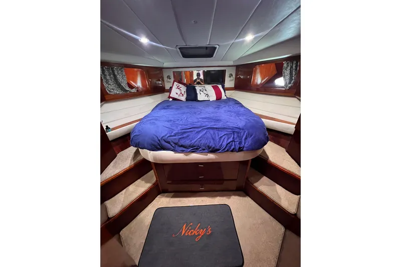 Nickys Yacht Photos Pics Luxurious cabin interior of 2003 Uniesse 48 Fly yacht with cozy bed and elegant decor.