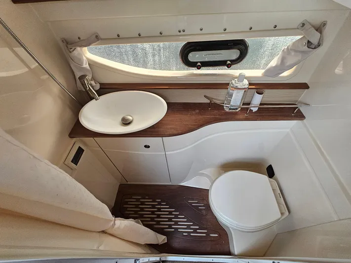 Knot On Call Yacht Photos Pics 2014 Sea Ray 350 Sundancer bathroom with sink, toilet, and window.