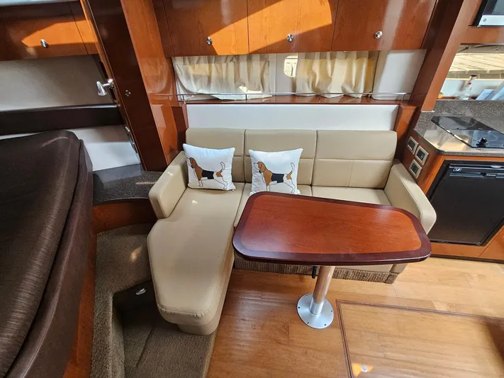 Knot On Call Yacht Photos Pics Luxurious interior of 2014 Sea Ray 350 Sundancer with beige seating and wooden table.