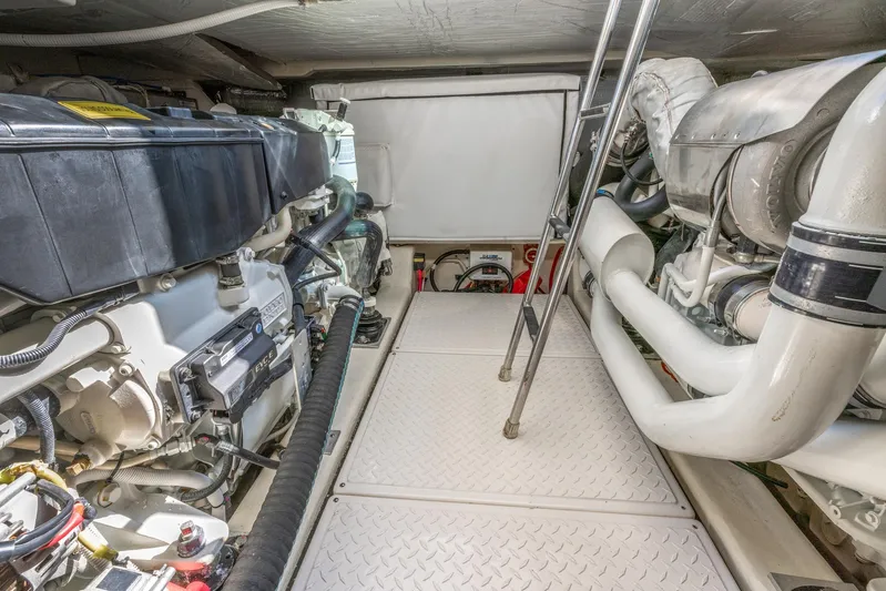 No Name Yacht Photos Pics Engine room of 2017 Tiara Yachts 53 Coupe with visible machinery and ladder.