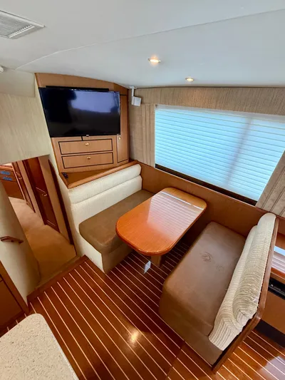 Split Decision Yacht Photos Pics Interior of 2005 Ocean Yachts 46 Super Sport with dining area and TV.