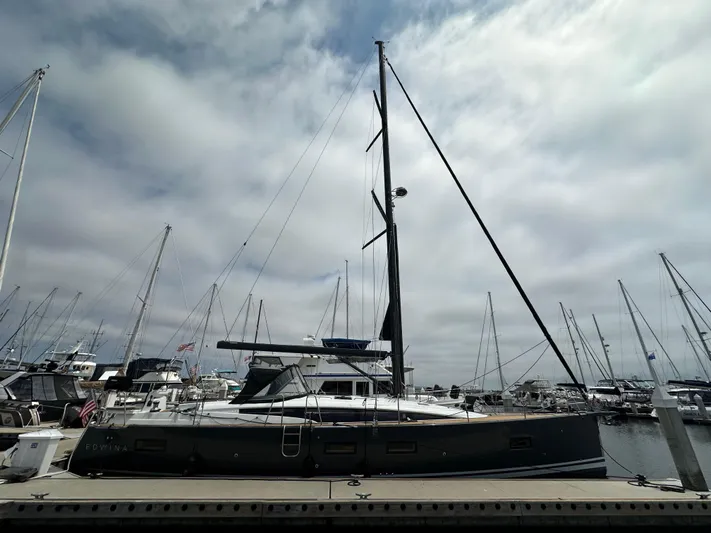 Edwina Yacht Photos Pics 2018 Jeanneau 54 sailboat docked at a marina under cloudy skies.