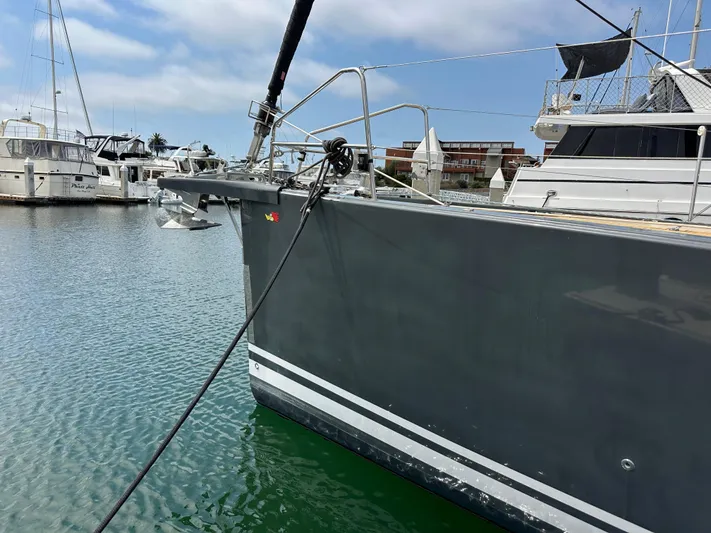 Edwina Yacht Photos Pics 2018 Jeanneau 54 yacht docked in marina, featuring sleek gray hull and anchor.