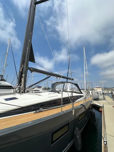Edwina Yacht Photos Pics 2018 Jeanneau 54 yacht docked at marina under blue sky.