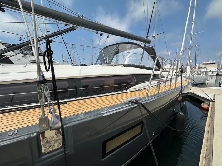 Edwina Yacht Photos Pics 2018 Jeanneau 54 yacht docked at marina, showcasing sleek design and wooden deck.