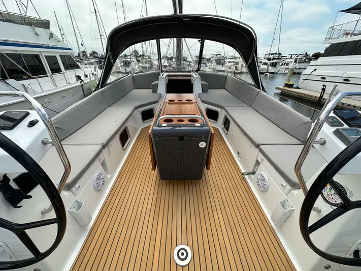 Edwina Yacht Photos Pics Spacious cockpit of a 2018 Jeanneau 54 yacht with elegant seating and wooden flooring.