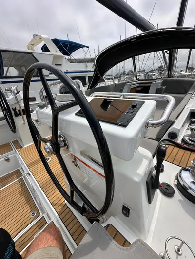 Edwina Yacht Photos Pics Steering wheel and controls of a 2018 Jeanneau 54 yacht, featuring teak decking.