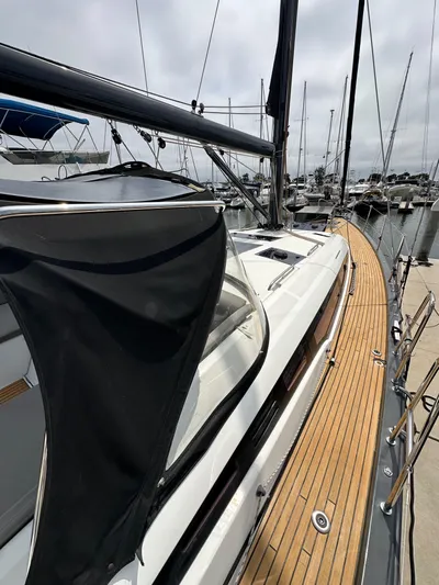 Edwina Yacht Photos Pics 2018 Jeanneau 54 sailboat with teak deck, docked at marina.