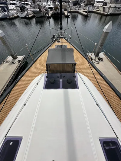 Edwina Yacht Photos Pics Jeanneau 54 yacht, 2018 model, docked at marina with wooden deck and canopy.