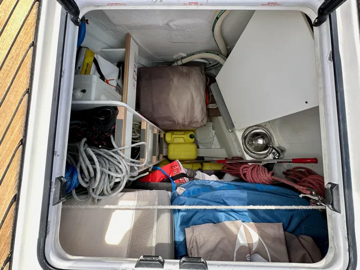 Edwina Yacht Photos Pics Storage compartment of a 2018 Jeanneau 54 sailboat with ropes and equipment.