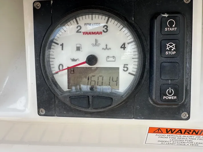 Edwina Yacht Photos Pics Control panel of a 2018 Jeanneau 54 sailboat with Yanmar tachometer and warning label.