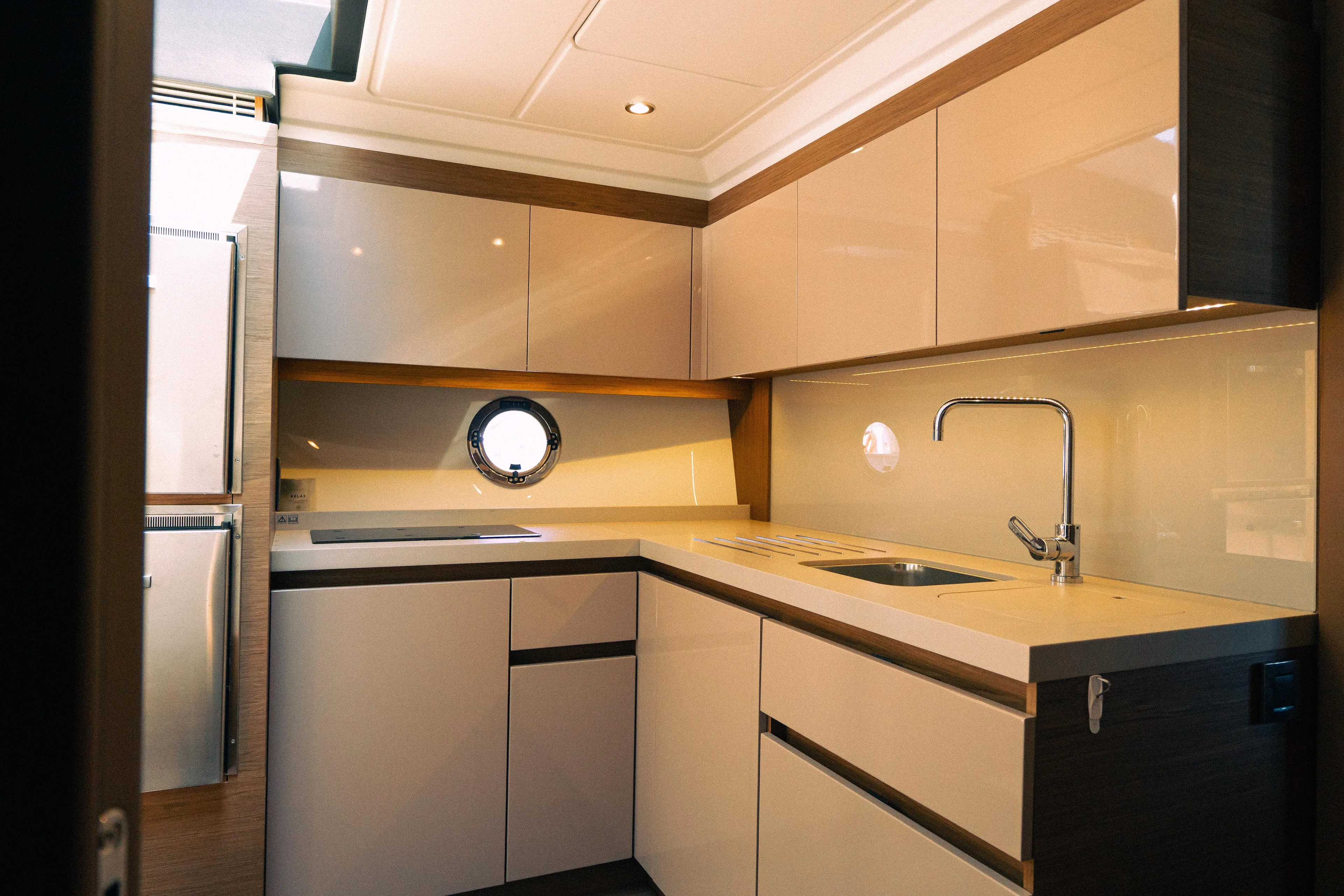 Gracia Yacht Photos Pics Modern kitchen interior of 2019 Beneteau Gran Turismo 50 yacht, featuring sleek cabinetry and fixtures.